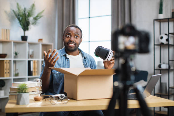 istock African american man opening parcel box and recording video 1363833093