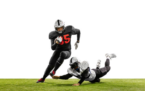 два игрока в американский футбол в действии, движение. спортсмены борются за мяч, изолированный на белом фоне на траве - квотербек стоковые фото и изображения