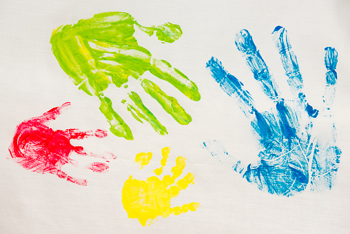 The colorful imprints of hands smeared with paint on a wise cloth