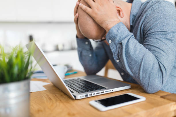 istock Unhappy man working from his home 1363833566