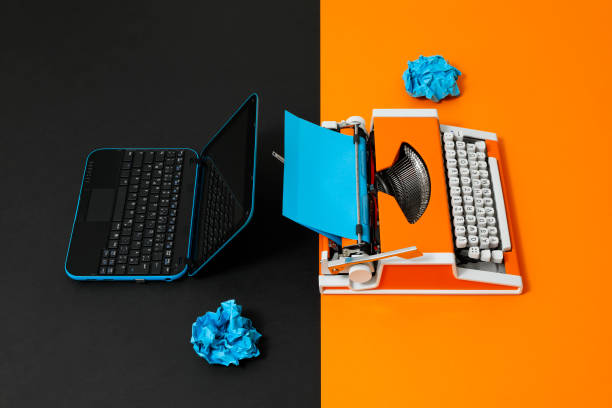 istock Digital and analog – Laptop and 70s Typewriter 1363833743