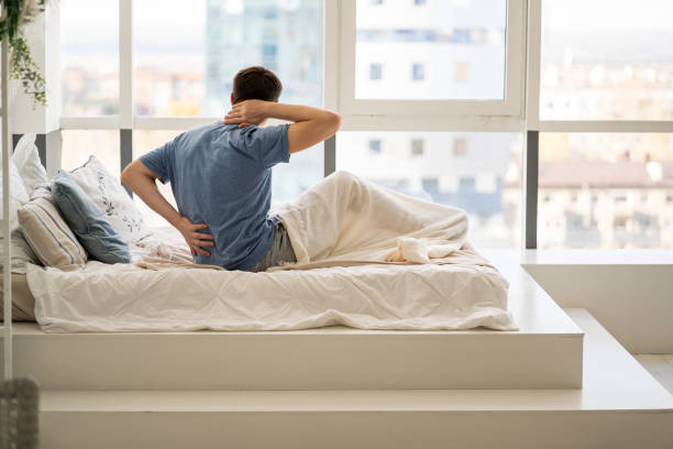istock Back pain, man with backache at bedroom 1363835791