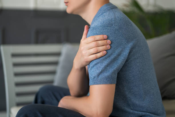 istock Man with pain in shoulder at home 1363835817