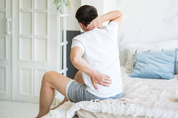 Back pain, man with backache at home stock photo