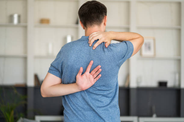 istock Pain between the shoulder blades, man suffering from backache at home 1363836360