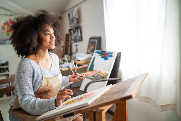 istock Afro female fine artist  drawing in studio 1363837229