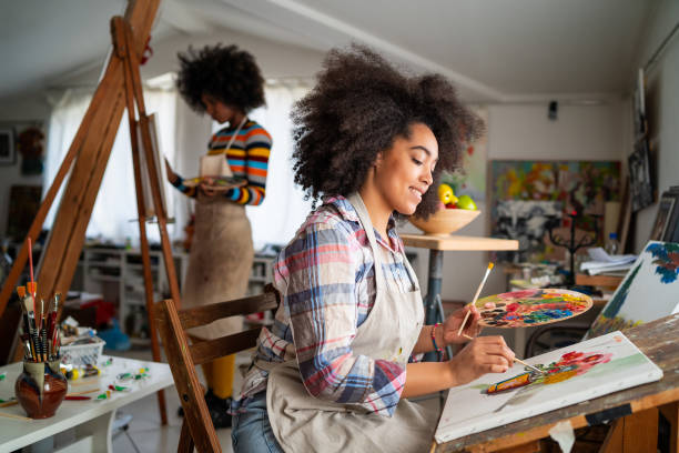istock Afro Female fine artists drawing in studio 1363837247