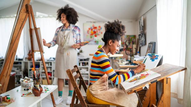 istock Afro female fine artists drawing in studio 1363837248
