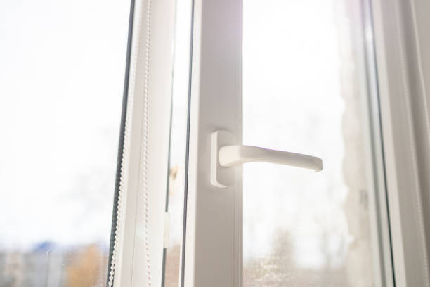 istock White plastic pvc window with forest background at home. Sunbeam through glass 1363839901