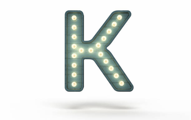 istock Letter K decorated with light bulb covered with green wood 1363840403
