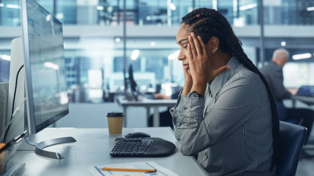 istock Black Female Corporate Office Worker Feels Stress, Sick, Frustration, Sick Works on Computer. Accountant Feeling Project Pressure, Has Headache Massages Her Head, Works with Statistics, Has Bad Day 1363841745