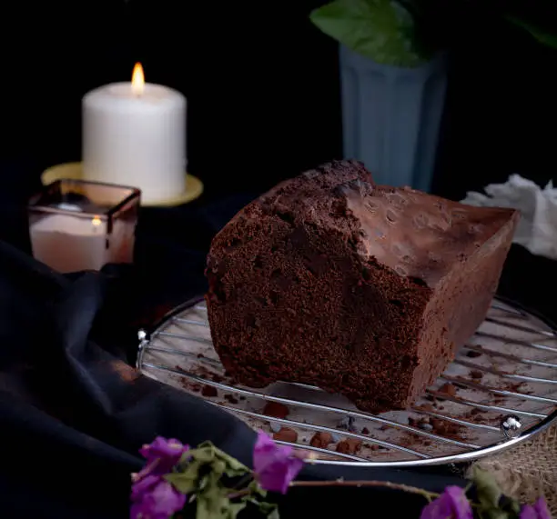 cut piece of chocolate and coffee plumcake with dark chocolate and cocoa drops