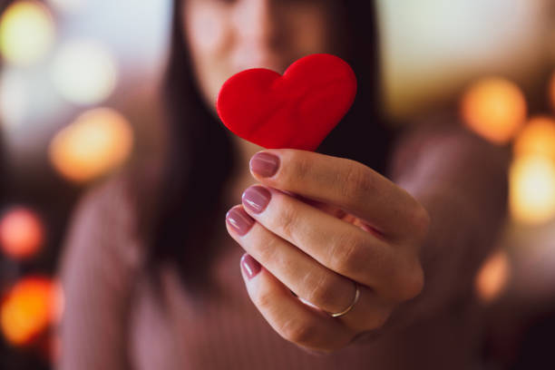istock Unrecognizable young woman holding a small red heart with one hand 1363842374
