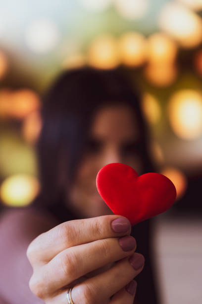 istock Unrecognizable young woman holding a small red heart with one hand 1363842409
