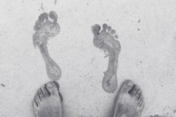 istock Wet male footprints on concrete surface 1363846341