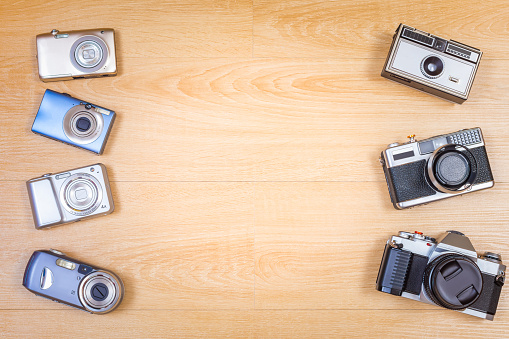 old cameras on wooden background