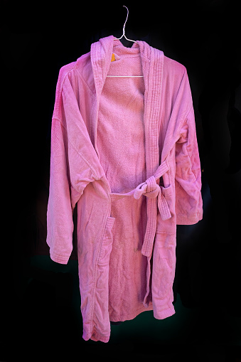 Soft pink bathrobe on silver hanger sold on market