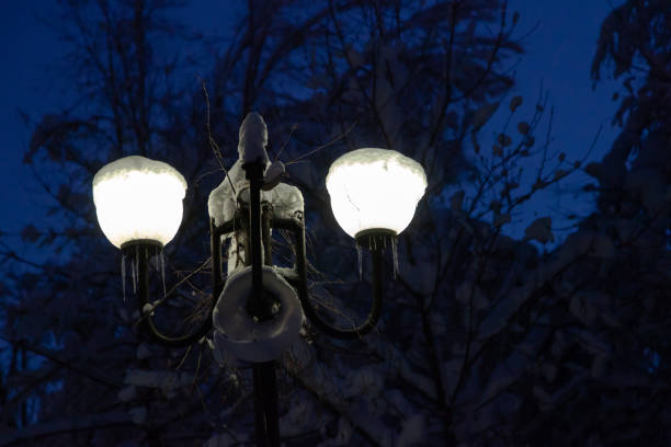 istock Two street lights shine on winter night 1363848472