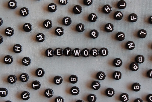 Alphabet beads with text KEYWORD on concrete floor