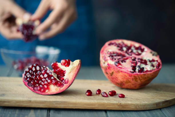 istock Woman Peeling Pomegranate 1363849697