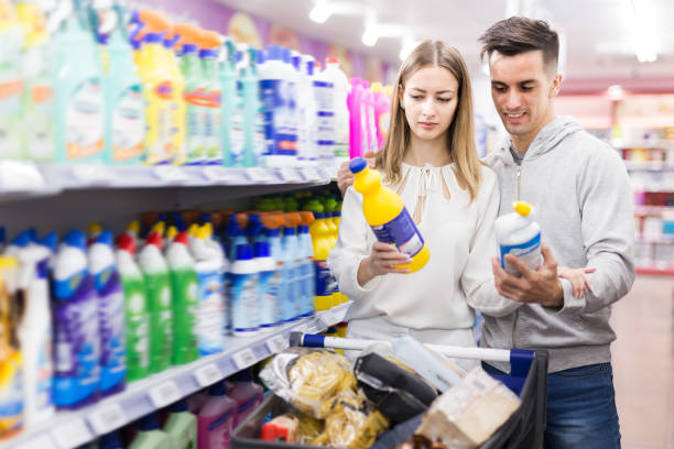 istock Cheerful couple choosing household detergents 1363850624
