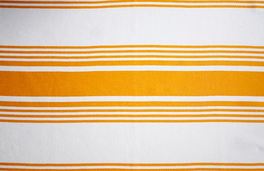 Istanbul, Turkey-January 7, 2022: Linen cotton tea towel with orange stripes on white. Shot with Canon EOS R5.