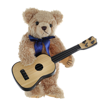 A cute teddy bear playing a guitar