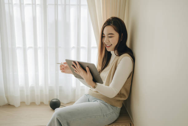 istock Young asian woman working at home with digital tablet 1363853056