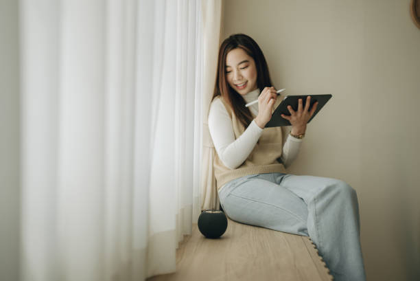 istock Young asian woman working at home with digital tablet 1363853117