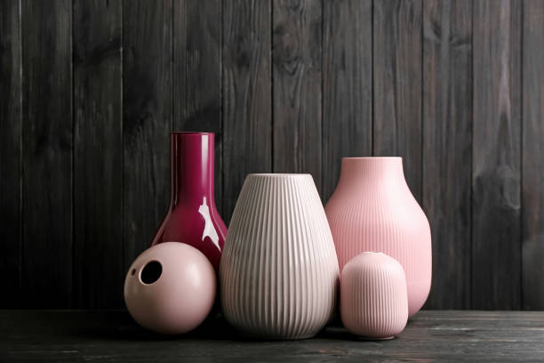 istock Stylish ceramic vases on black wooden table 1363853671