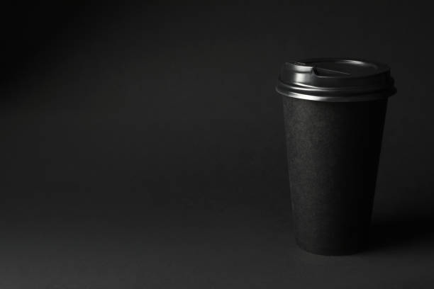 istock Takeaway paper coffee cup on dark background, space for text. Black Friday concept 1363854572