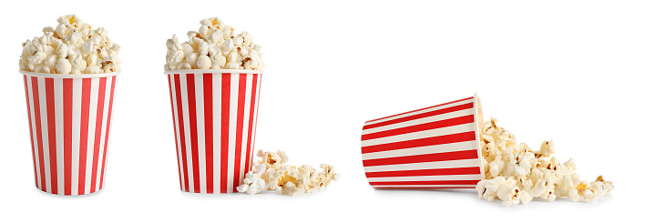 Set of paper cups with tasty popcorn on white background. Banner design
