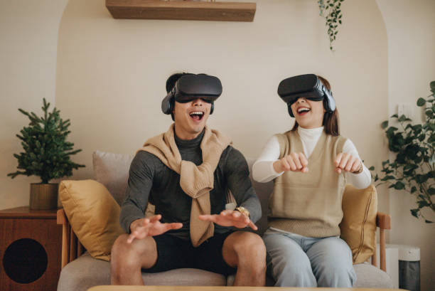 Friends with VR headset exploring virtual reality stock photo