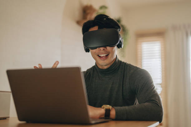 istock Asian man work from home with VR glasses at home. 1363855086