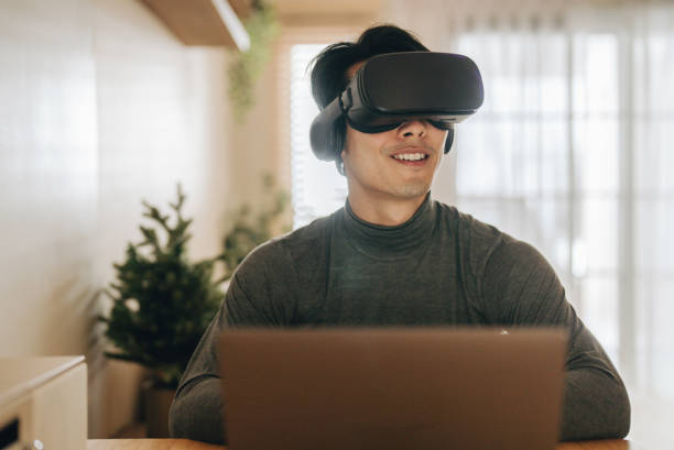 istock Asian man work from home with VR glasses at home. 1363855118