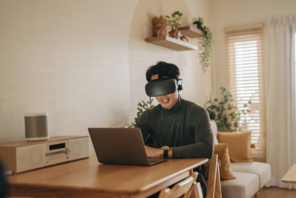 istock Asian man work from home with VR glasses at home. 1363855159