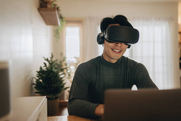istock Asian man work from home with VR glasses at home. 1363855164