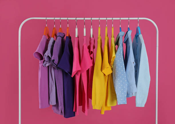 istock Rack with stylish children clothes on pink background 1363857228