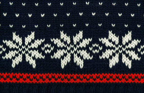 Traditional knitted blue sweater with snowflakes stock photo