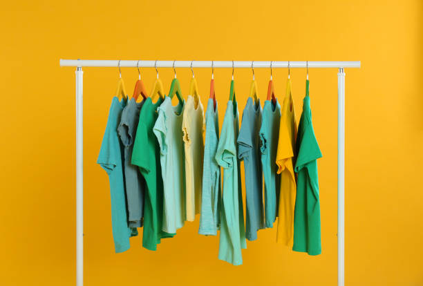 istock Rack with stylish children clothes on yellow background 1363857260