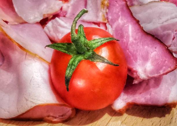Red tomato with green leaves
