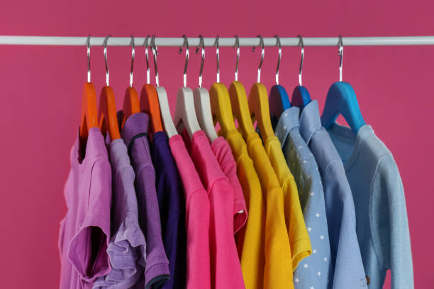 istock Rack with stylish children clothes on pink background 1363857664