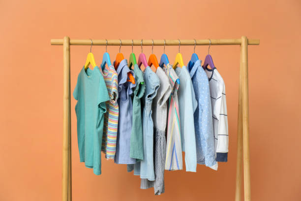 istock Rack with stylish children clothes on beige background 1363857668