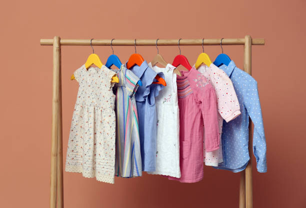 istock Rack with stylish children clothes on beige background 1363857682