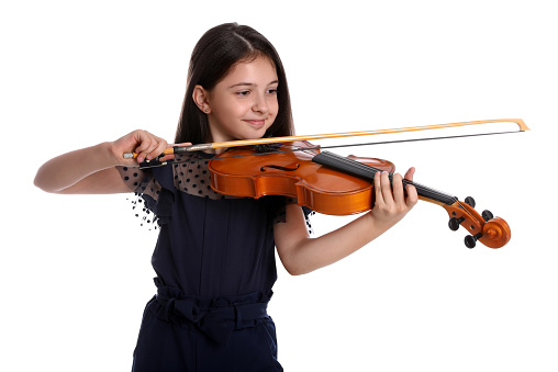 Preteen girl playing violin on white background