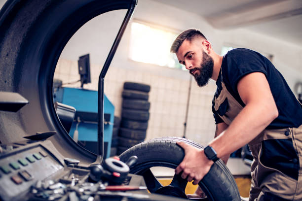 istock Young repairman changing tires 1363858803