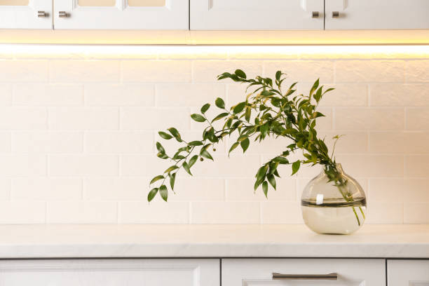 istock Decorative vase with branch on counter in kitchen 1363858943