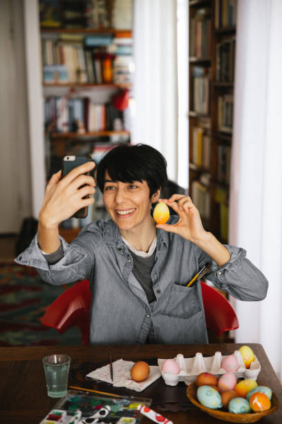 istock Woman takes a selfie with painted Easter eggs 1363859199