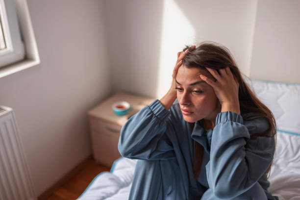 istock Depressed woman holding head in hands 1363859224
