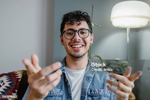 Young Man Talking On A Video Call And Looking At The Camera Stock Photo - Download Image Now